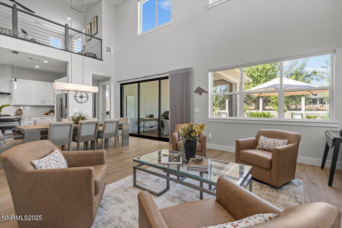 5517 Western Rider Trail Reno, NV 89511 - Photo 16 of 49 a living room with furniture a chandelier and a large window