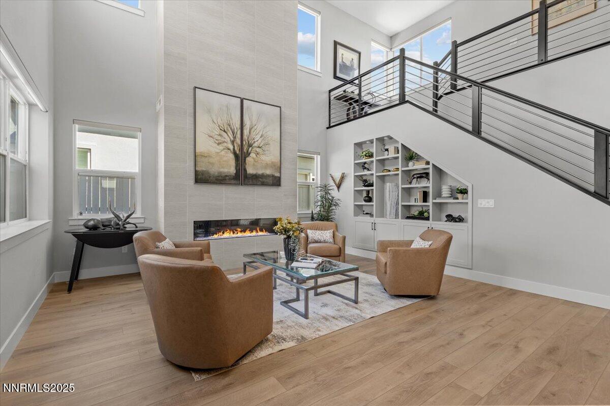 5517 Western Rider Trail Reno, NV 89511 - Photo 17 of 49 a living room with couches a fireplace and cabinet with wooden floor
