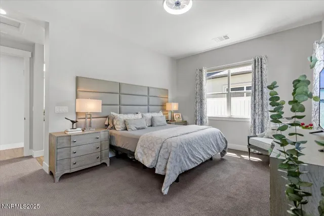 a bed room with a bed window and a dresser