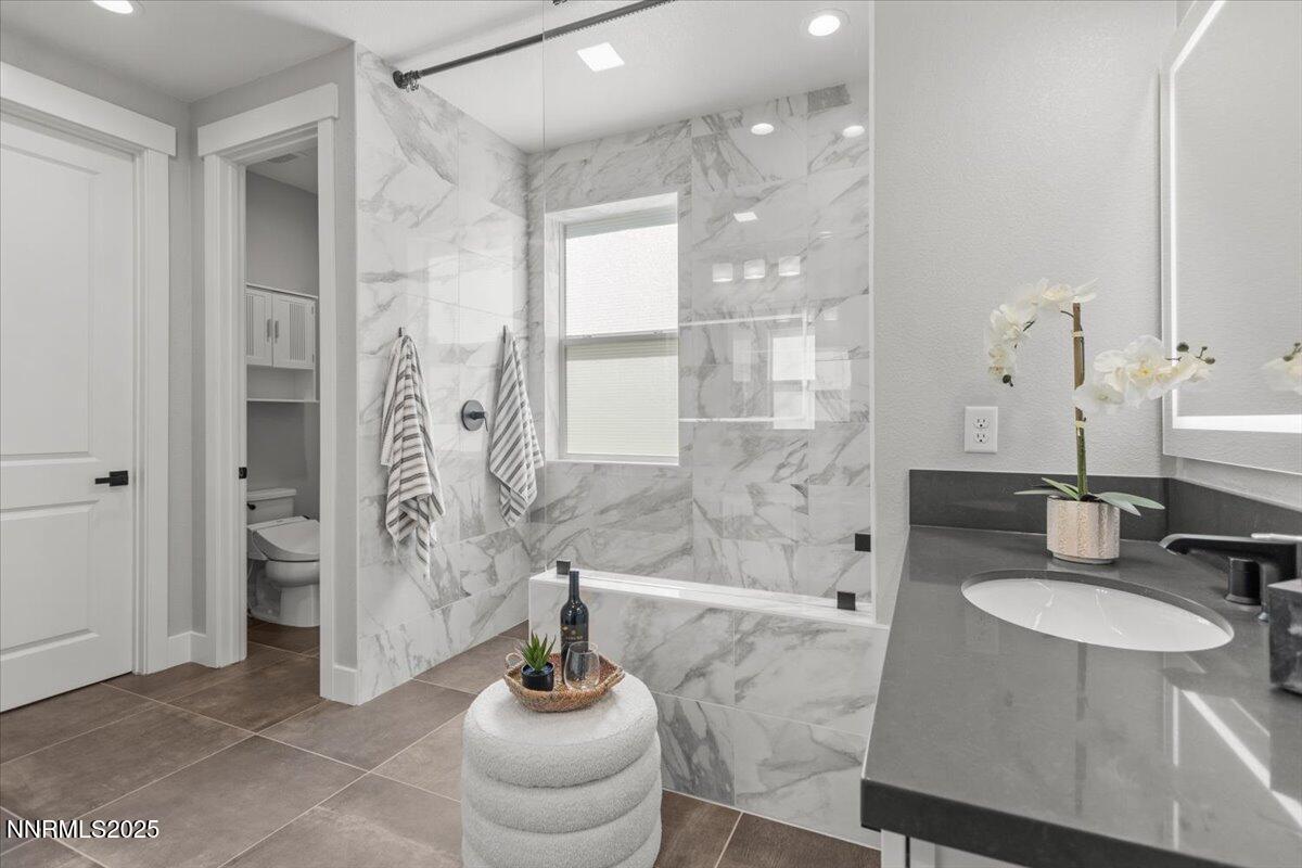 5517 Western Rider Trail Reno, NV 89511 - Photo 21 of 49 a bathroom with a sink a toilet and shower