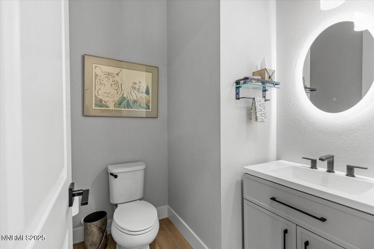 5517 Western Rider Trail Reno, NV 89511 - Photo 25 of 49 a bathroom with a toilet sink vanity and mirror