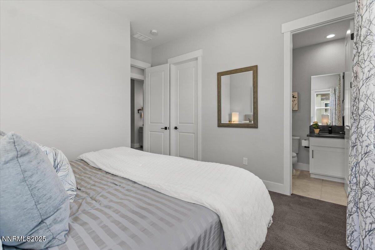 5517 Western Rider Trail Reno, NV 89511 - Photo 28 of 49 a bedroom with a bed and a mirror