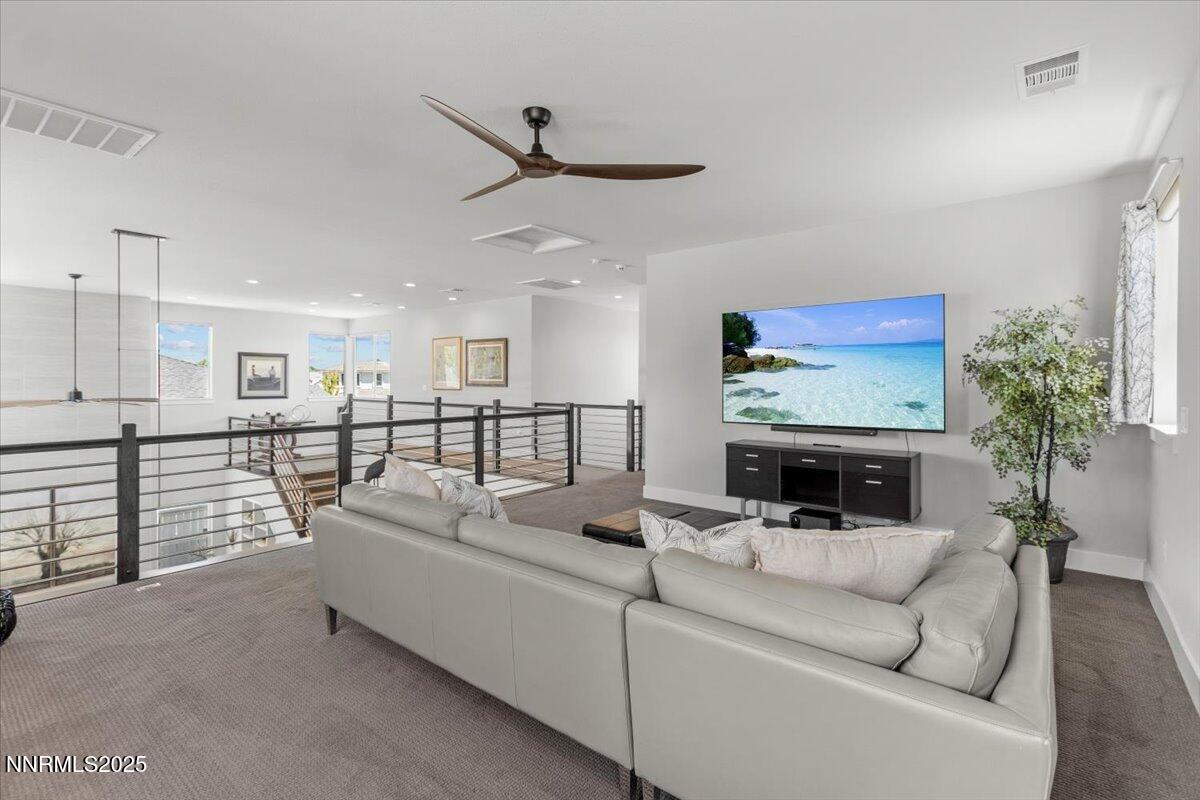 5517 Western Rider Trail Reno, NV 89511 - Photo 30 of 49 a living room with furniture and a flat screen tv