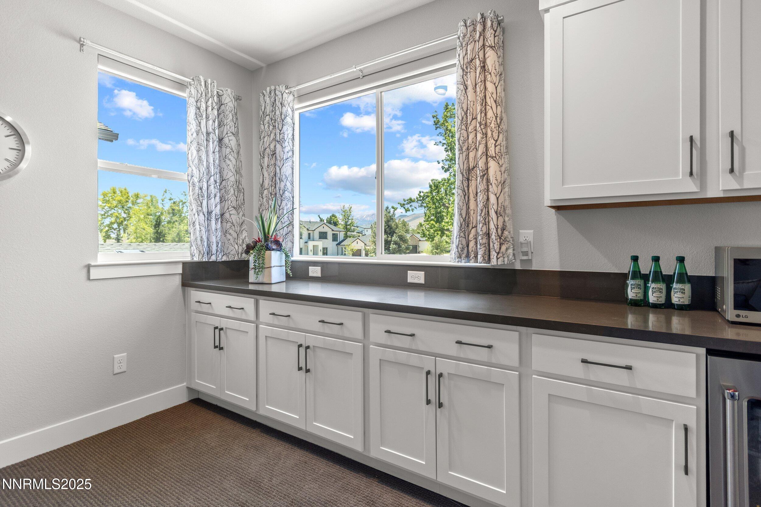 5517 Western Rider Trail Reno, NV 89511 - Photo 32 of 49 a kitchen with granite countertop white cabinets and a window