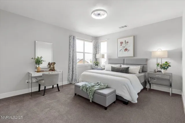 a spacious bedroom with a bed and a cabinets