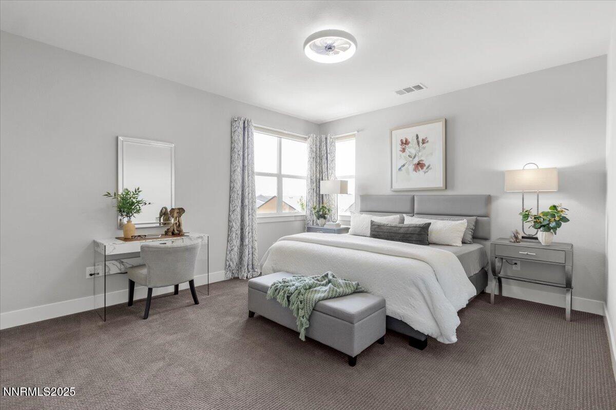 5517 Western Rider Trail Reno, NV 89511 - Photo 33 of 49 a bedroom with a bed and a table in it