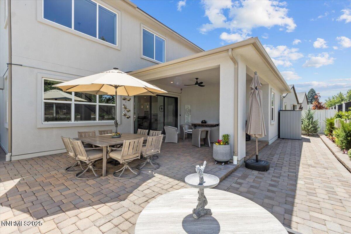 5517 Western Rider Trail Reno, NV 89511 - Photo 37 of 49 a view of a patio with couches table and chairs under an umbrella with a barbeque