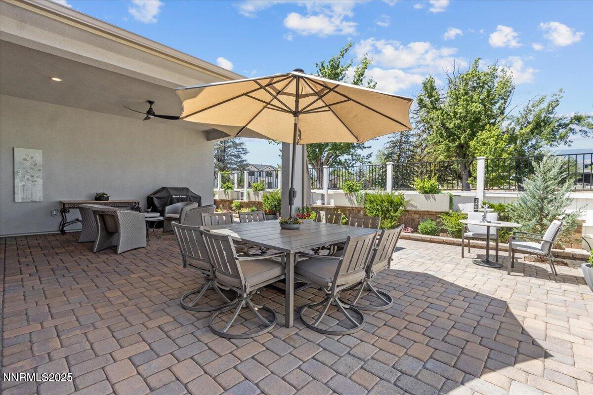 5517 Western Rider Trail Reno, NV 89511 - Photo 40 of 49 a view of a patio with a table and chairs under an umbrella