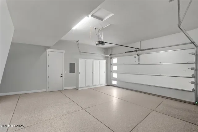 an aerial view of a city with lots of residential buildings and mountain view in back