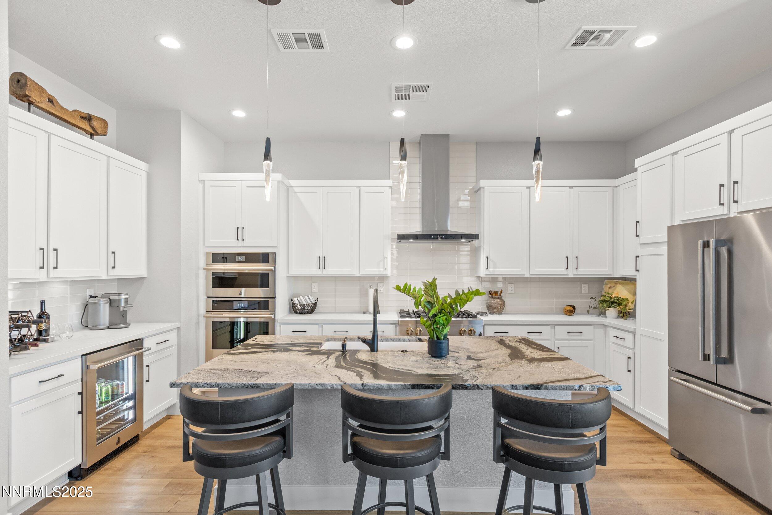 5517 Western Rider Trail Reno, NV 89511 - Photo 7 of 49 a kitchen with refrigerator a sink and chairs