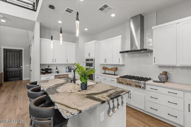 a kitchen with a table chairs stove and cabinets