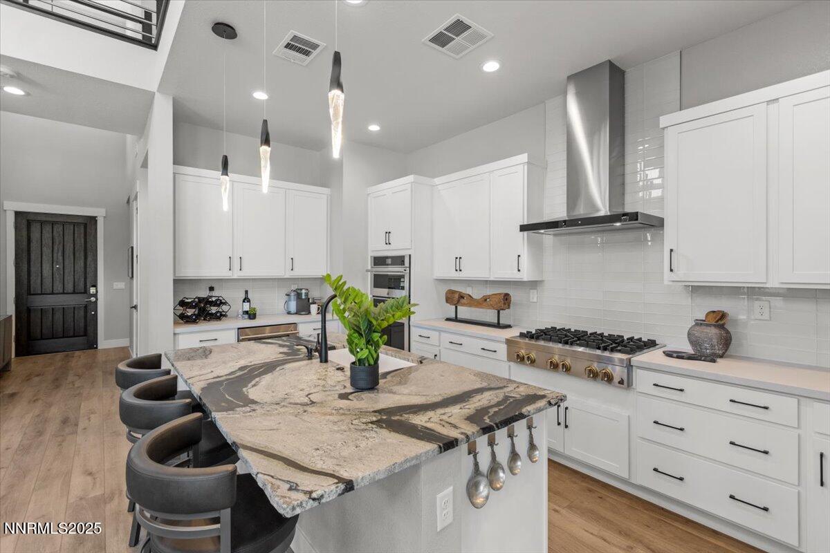 5517 Western Rider Trail Reno, NV 89511 - Photo 8 of 49 a kitchen with a table chairs stove and cabinets