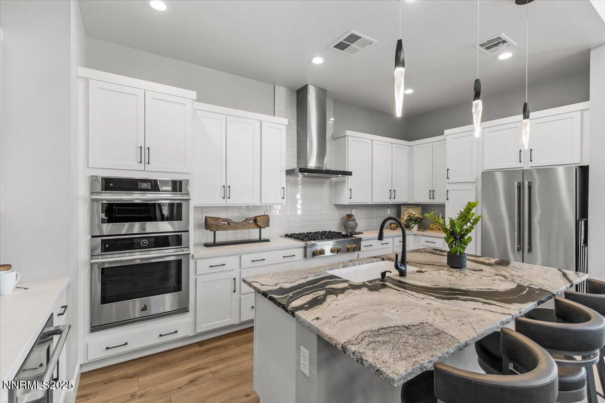 5517 Western Rider Trail Reno, NV 89511 - Photo 10 of 49 a kitchen with stainless steel appliances granite countertop a stove a sink a refrigerator and a refrigerator