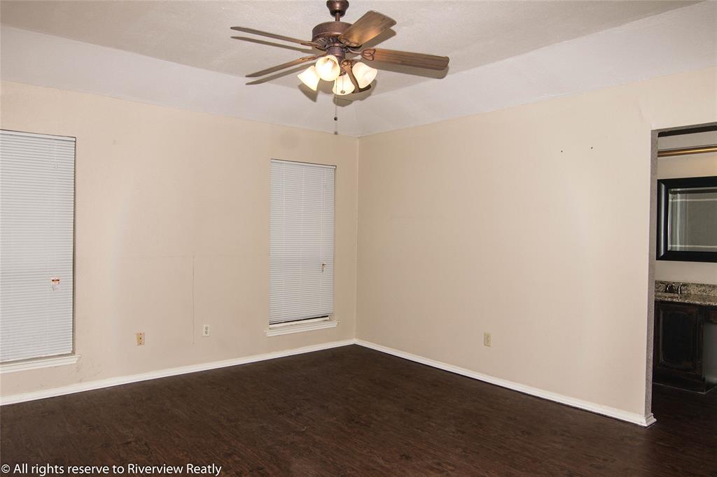 2019 West Nathan Lowe Road Arlington, TX 76017 - Photo 16 of 21 Split master bedroom Spacious room featuring wood-finish flooring, light-toned walls, and a ceiling fan with integrated lighting