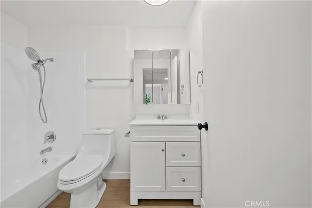 a bathroom with a bath tub with a shower
