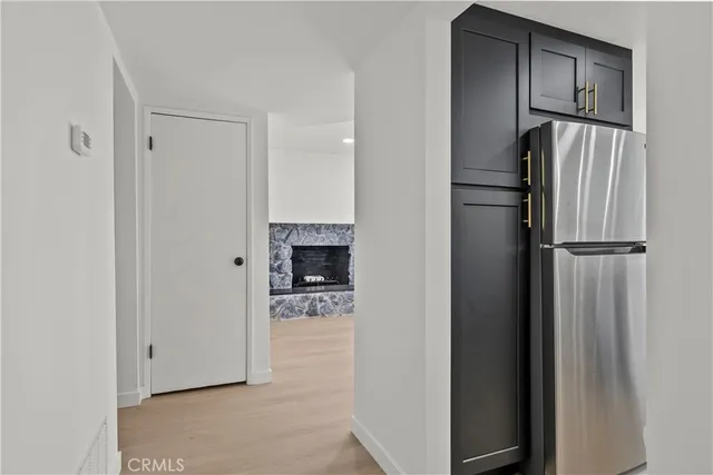 a kitchen with stainless steel appliances granite countertop a sink and a refrigerator