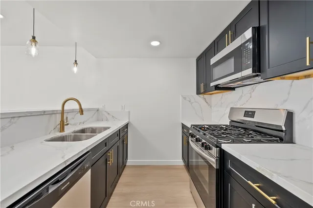a kitchen with a sink and a refrigerator