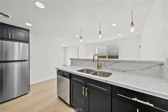 a kitchen with stainless steel appliances granite countertop a sink stove and microwave