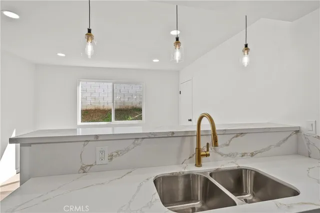 a view of a kitchen with a refrigerator and window