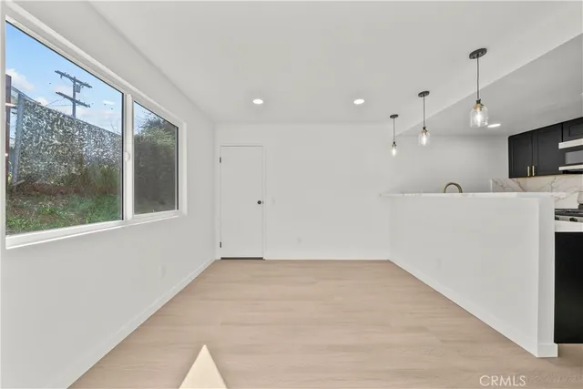a view of a kitchen with a sink a refrigerator and microwave