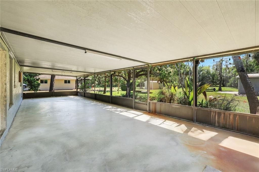 5290 Cypress Lane Naples, FL 34113 - Photo 27 of 39 a view of a porch with wooden floor