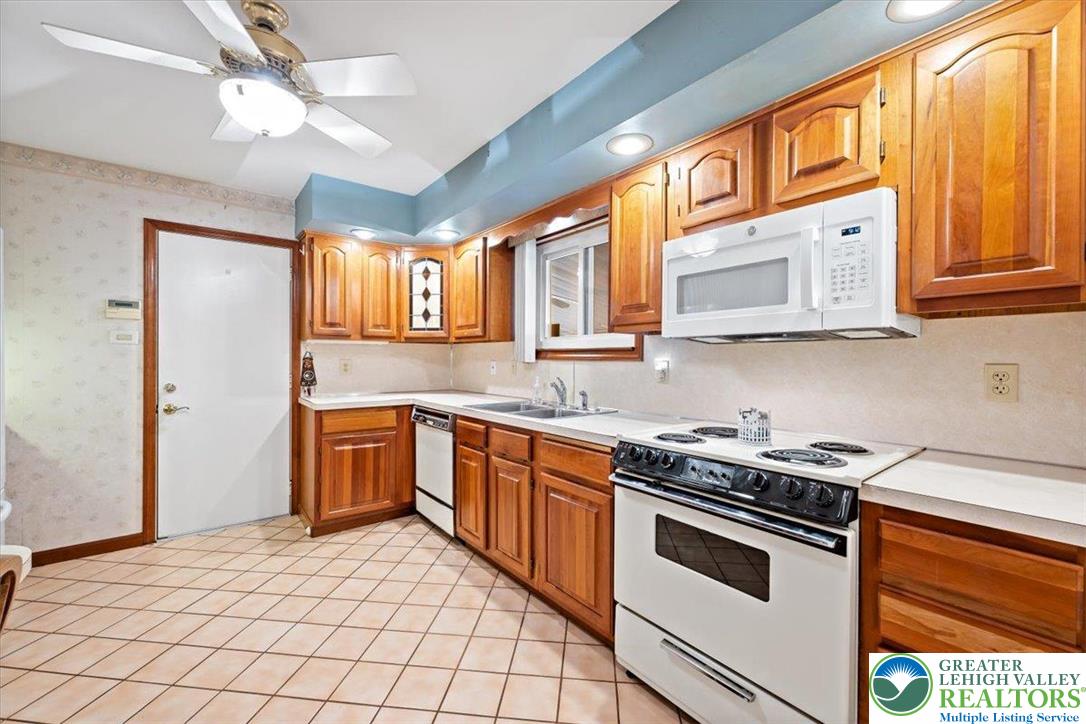 1240 Ridge Avenue Whitehall, PA 18052 - Photo 13 of 52 a kitchen with stainless steel appliances granite countertop a stove a sink and a microwave