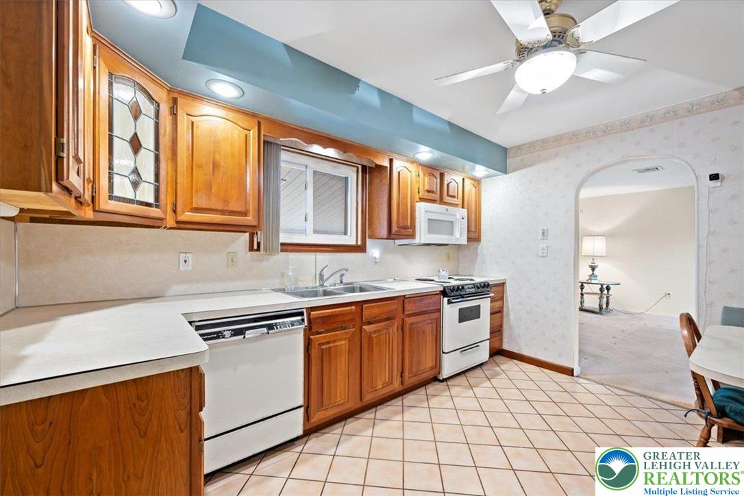 1240 Ridge Avenue Whitehall, PA 18052 - Photo 14 of 52 a kitchen with stainless steel appliances granite countertop a sink and cabinets