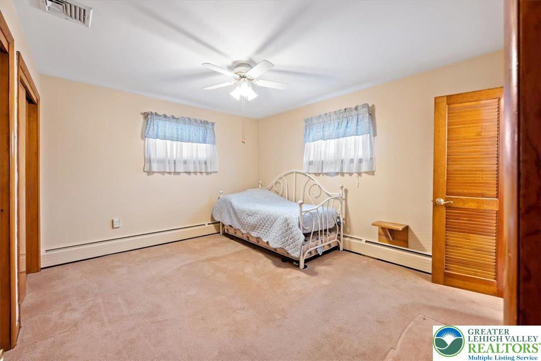 1240 Ridge Avenue Whitehall, PA 18052 - Photo 19 of 52 a spacious bedroom with a bed and a window