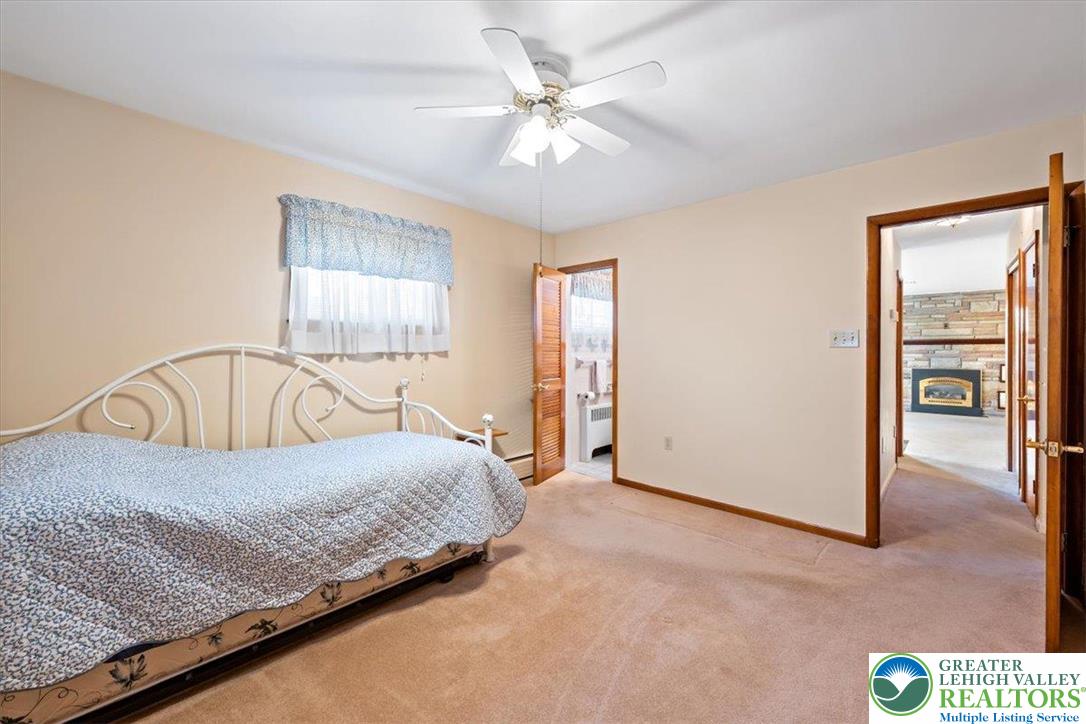 1240 Ridge Avenue Whitehall, PA 18052 - Photo 20 of 52 a bedroom with a bed and a chandelier