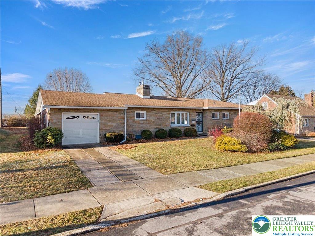 1240 Ridge Avenue Whitehall, PA 18052 - Photo 2 of 52 a front view of a house with a garden and yard