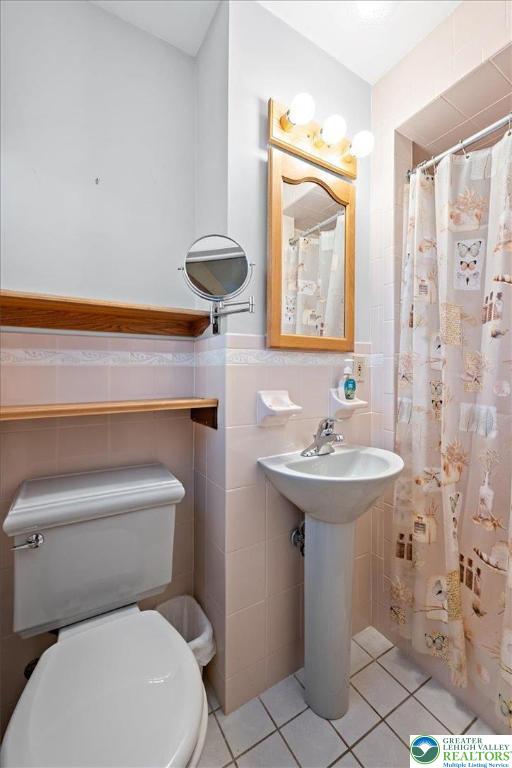 1240 Ridge Avenue Whitehall, PA 18052 - Photo 22 of 52 a bathroom with a sink a toilet and shower curtain