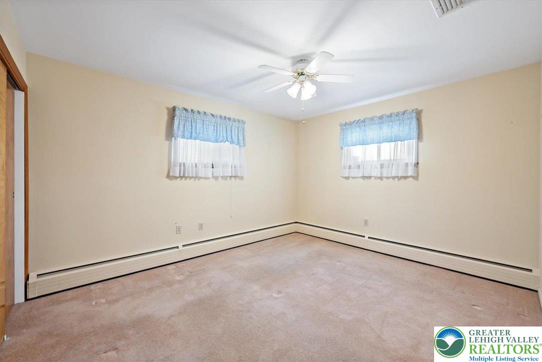 1240 Ridge Avenue Whitehall, PA 18052 - Photo 23 of 52 an empty room with windows and fan