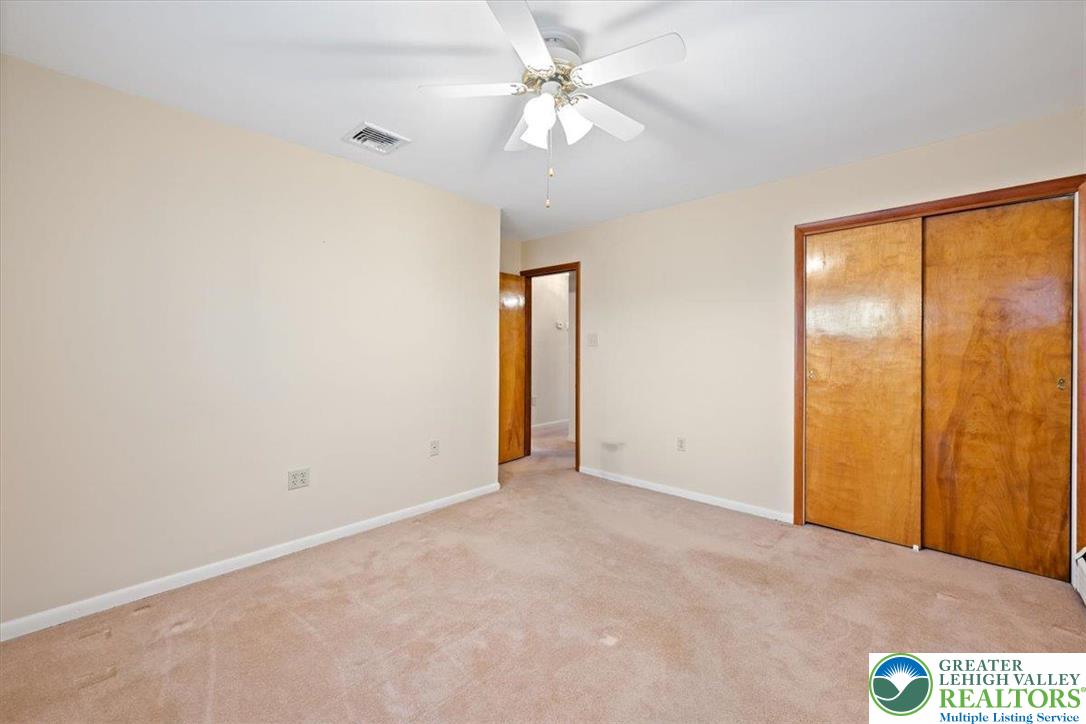 1240 Ridge Avenue Whitehall, PA 18052 - Photo 26 of 52 an empty room with fan and a chandelier fan