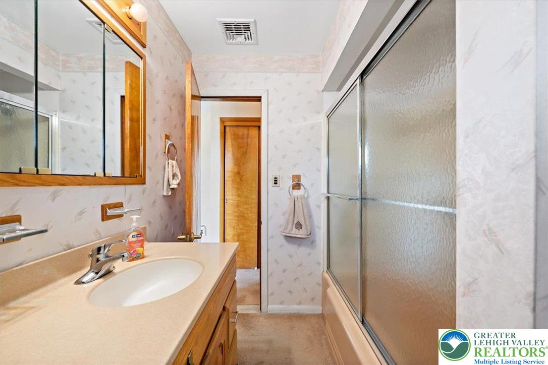 1240 Ridge Avenue Whitehall, PA 18052 - Photo 28 of 52 a bathroom with a sink and a large mirror