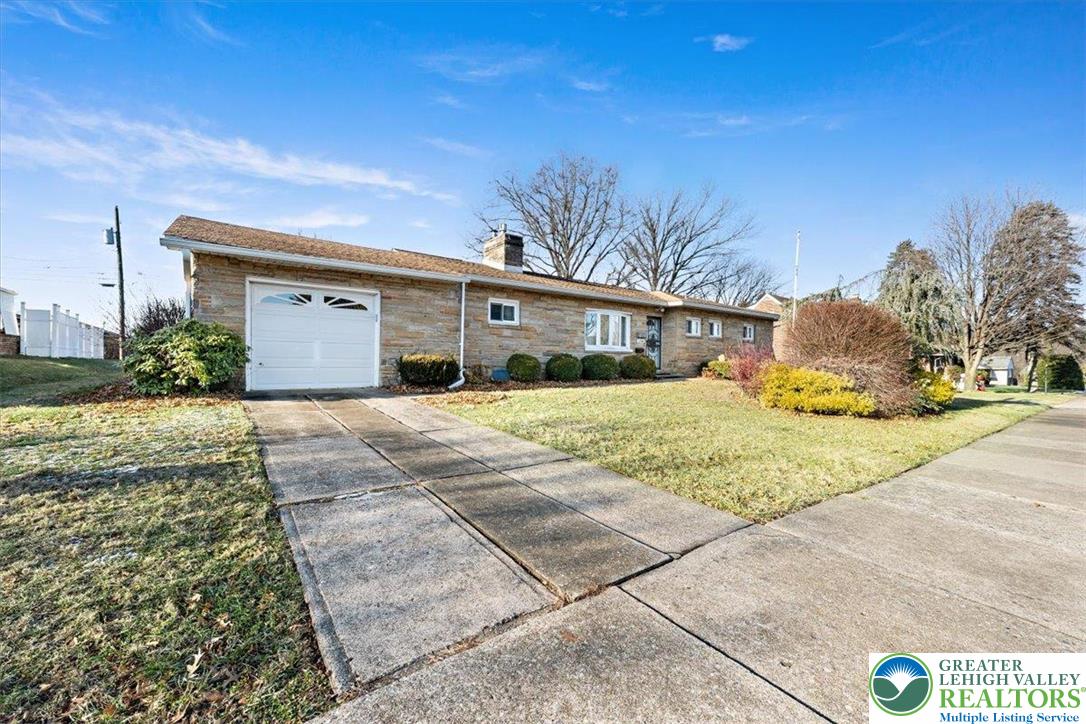 1240 Ridge Avenue Whitehall, PA 18052 - Photo 47 of 52 a front view of a house with a yard and garage