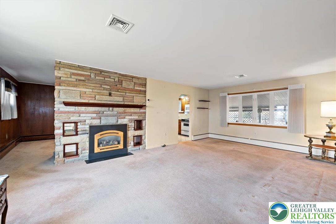 1240 Ridge Avenue Whitehall, PA 18052 - Photo 9 of 52 a view of a livingroom with a fireplace and a window