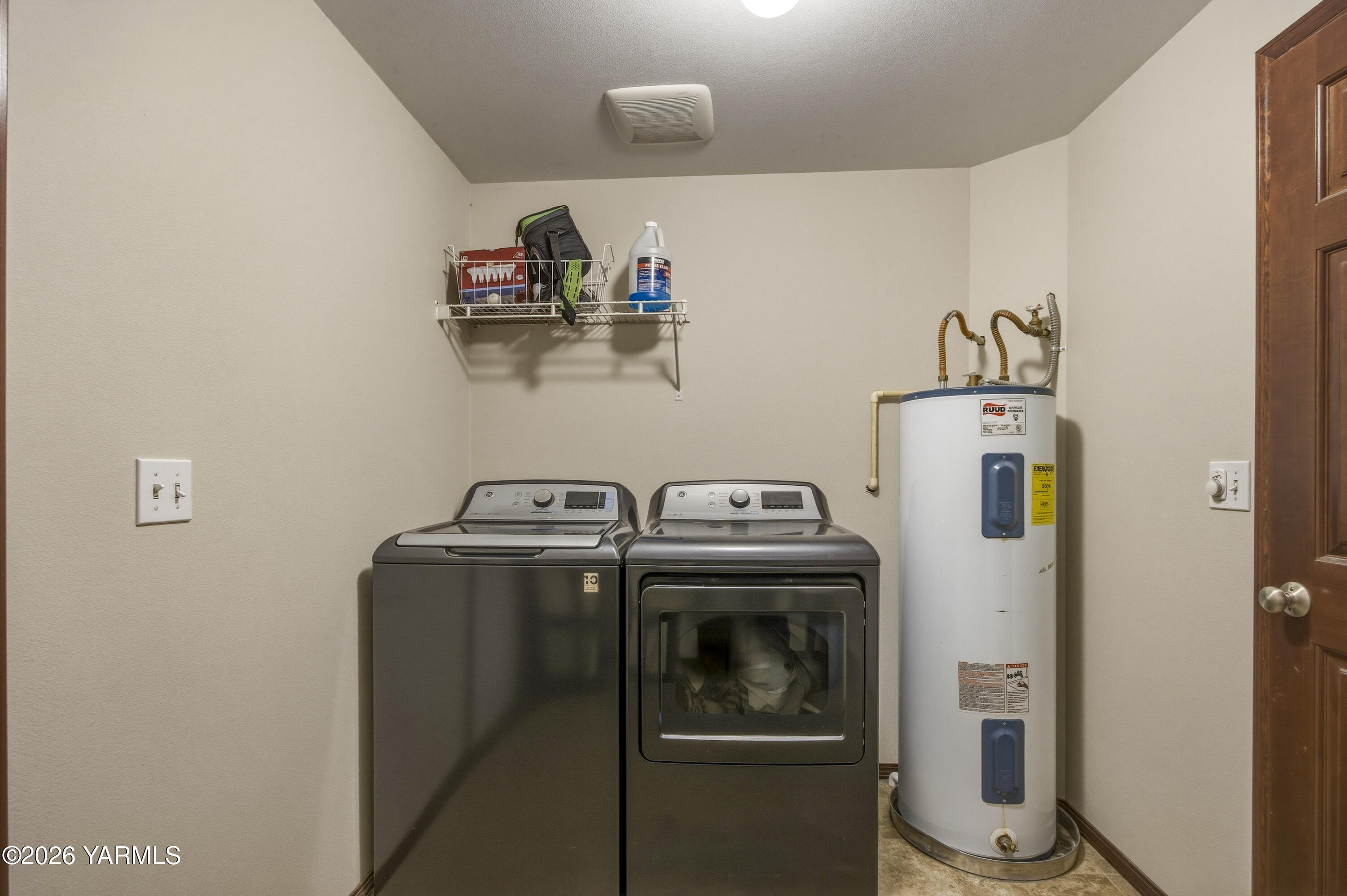 2050 Olmstead Road Grandview, WA 98930 - Photo 40 of 60 a view of storage and utility room with washer and dryer
