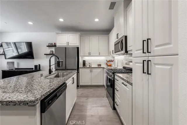 a living room with furniture wooden floor and a large window