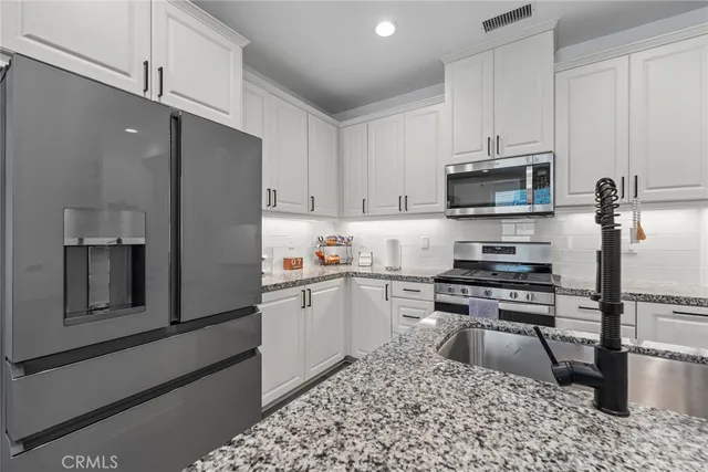a living room with fireplace furniture and a potted plant