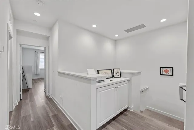 a spacious bedroom with a bed and a chandelier