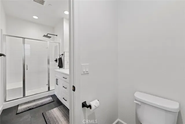 a bathroom with a sink toilet a mirror and shower