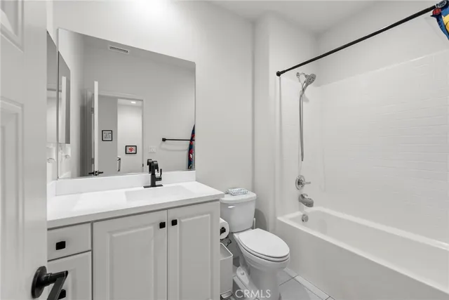 a view of a patio with a table and chairs under an umbrella