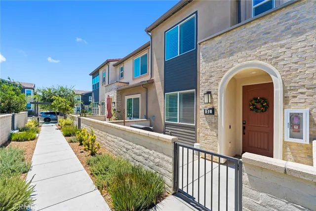a living room with stainless steel appliances kitchen island furniture and a flat screen tv