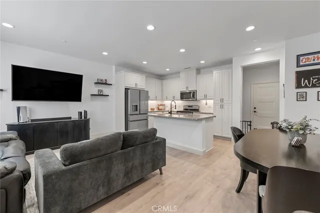 a living room with furniture and kitchen view