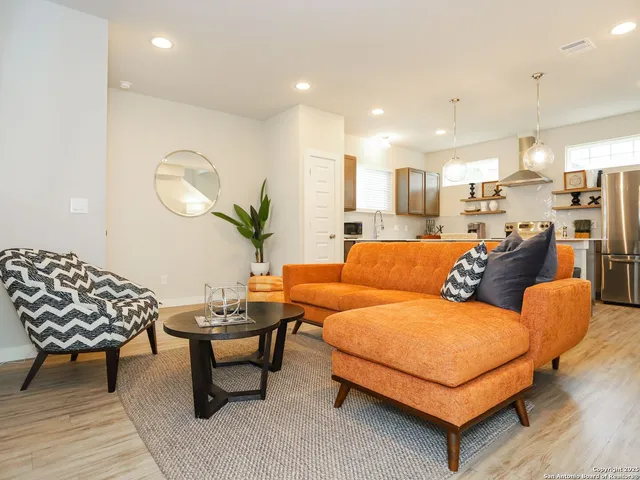 a living room with furniture and a potted plant