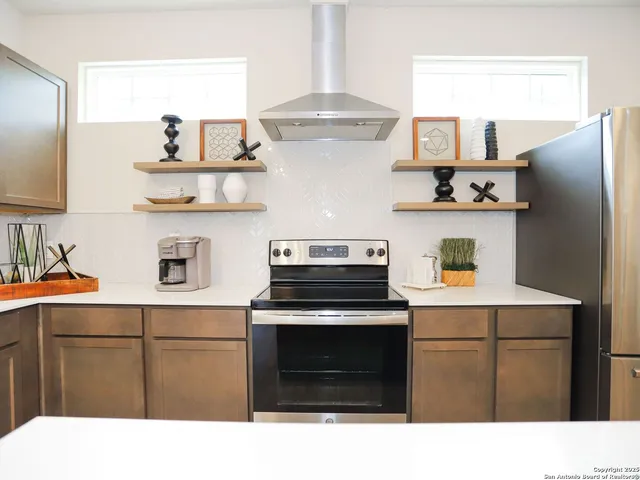 a kitchen with stainless steel appliances a stove and cabinets