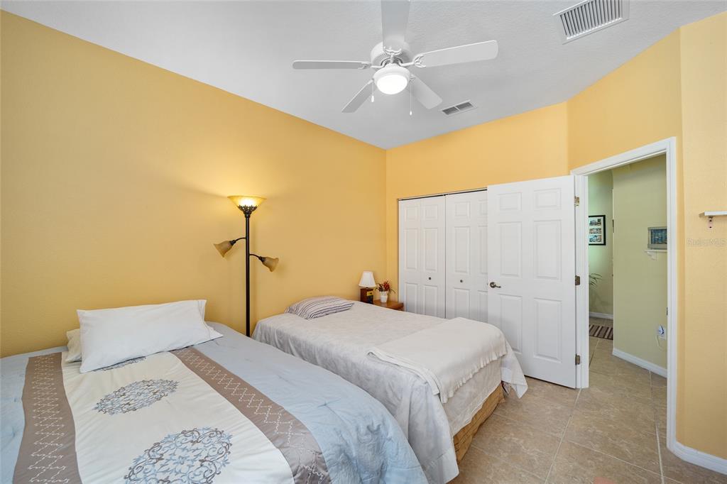 7947 South W 83rd Place Ocala, FL 34476 - Photo 13 of 28 a bedroom with a bed and a chandelier