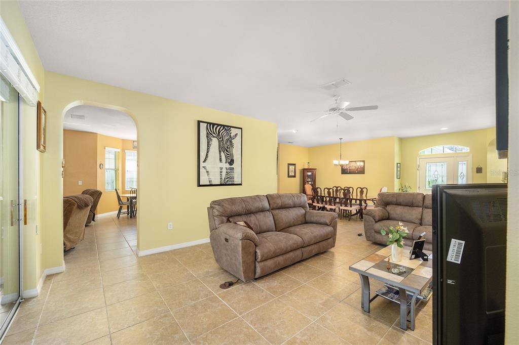 7947 South W 83rd Place Ocala, FL 34476 - Photo 24 of 28 a living room with furniture and a dining table with kitchen view