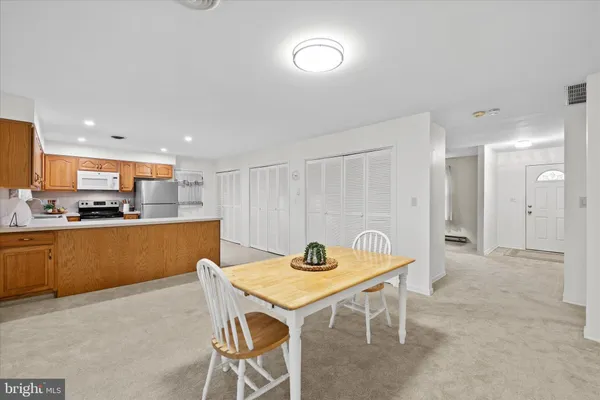 a kitchen with stainless steel appliances kitchen island granite countertop a sink and cabinets