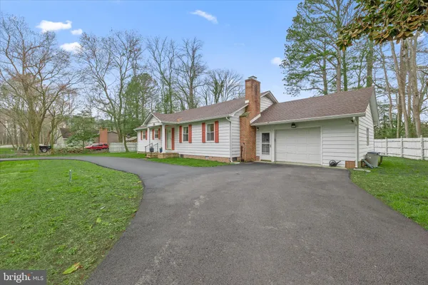 a view of a house with a yard and tree s